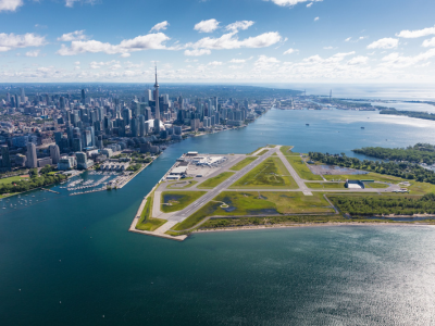 Aerial image of Billy Bishop Toronto City Airport with skyline in background.