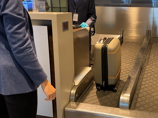 Lady with her bag on movator at check-in