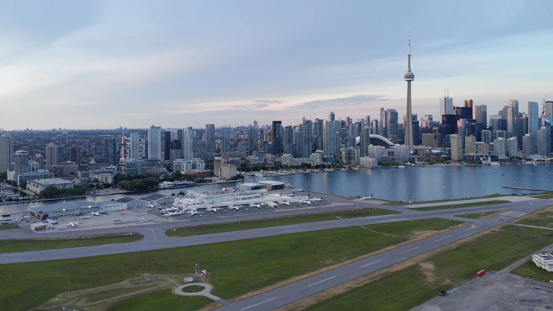 An aerial photo - Billy Bishop Toronto City Airport in foreground and the Toronto city skyline in the background.