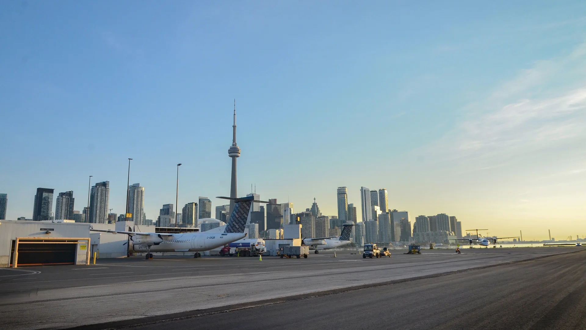 Billy Bishop Toronto City Airport runway with planes and downtown Toronto in background
