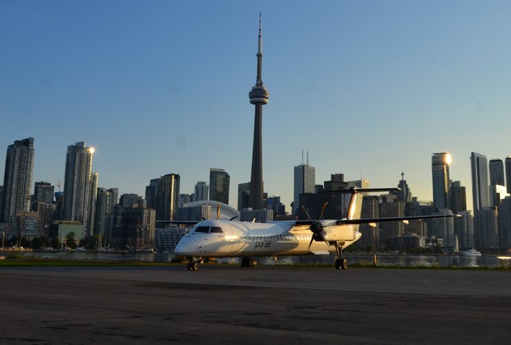 Porter airline plane on the runway with downtown Toronto in the background