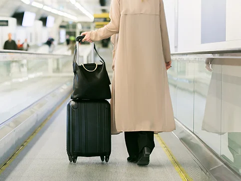 Business woman standing on a movator