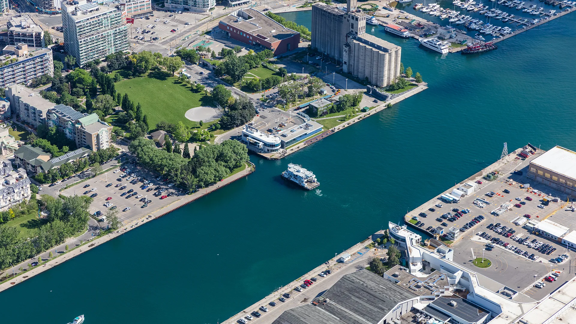 Aerial photo of the channel between the mainland and the island with the ferry navigating from the mainland to the island