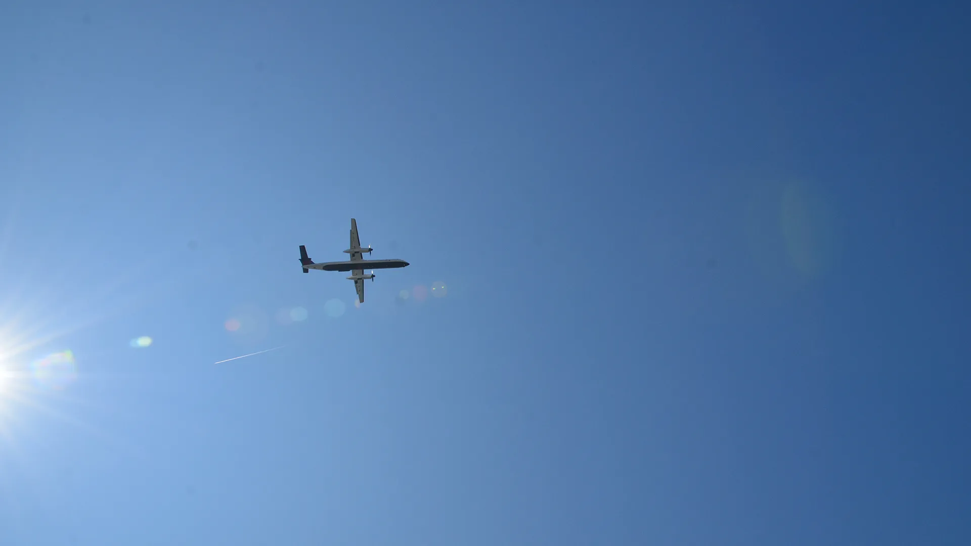 Airplane in a bright blue sky