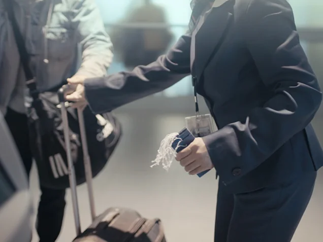 Airport staff helping with a bag and tags