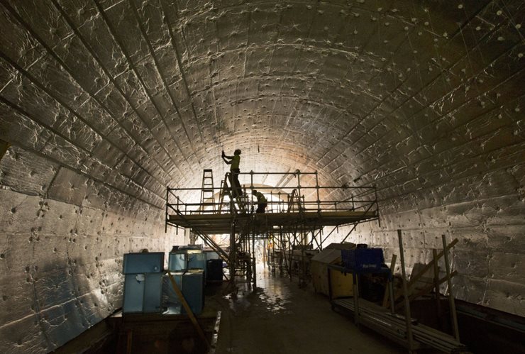 Tunnel with workers on ceiling