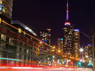 Long exposure photo of traffic with the CN Tower in the background at night