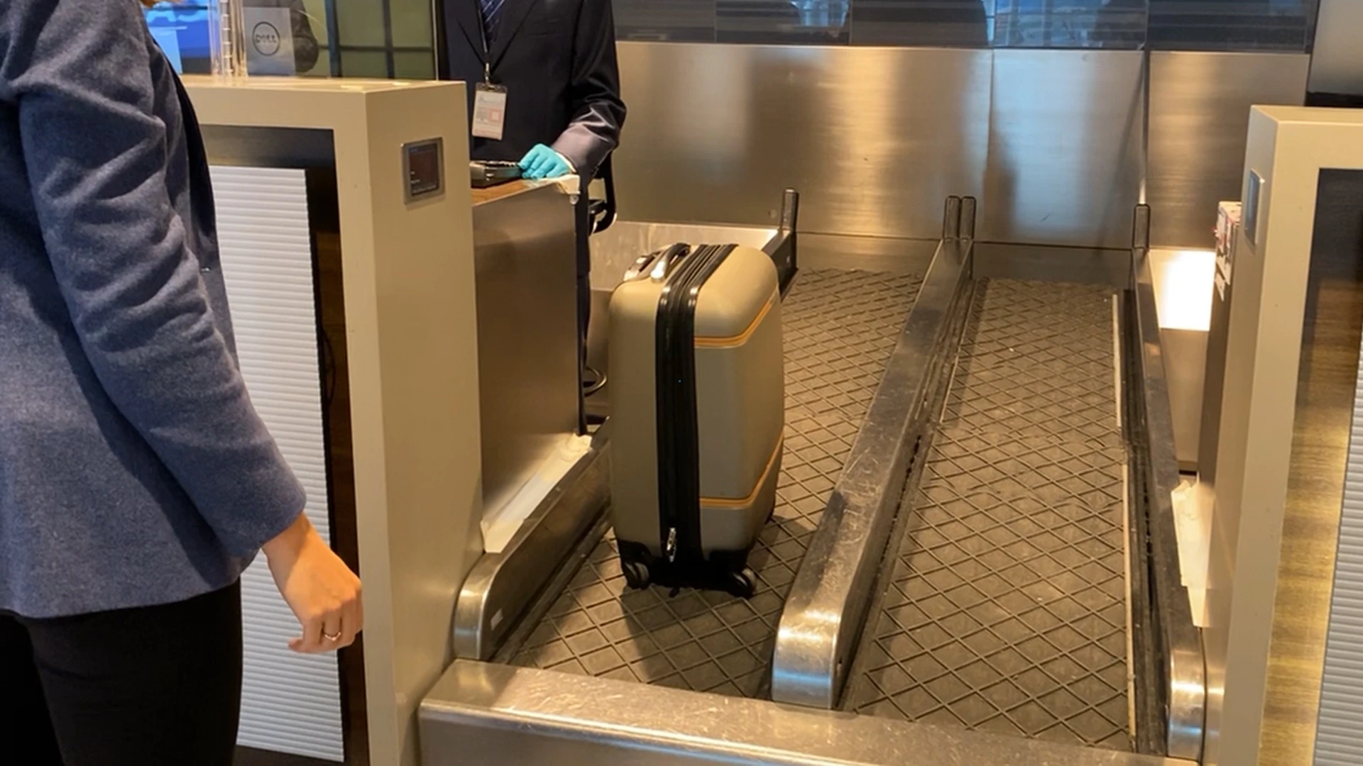 Lady with her bag on movator at check-in