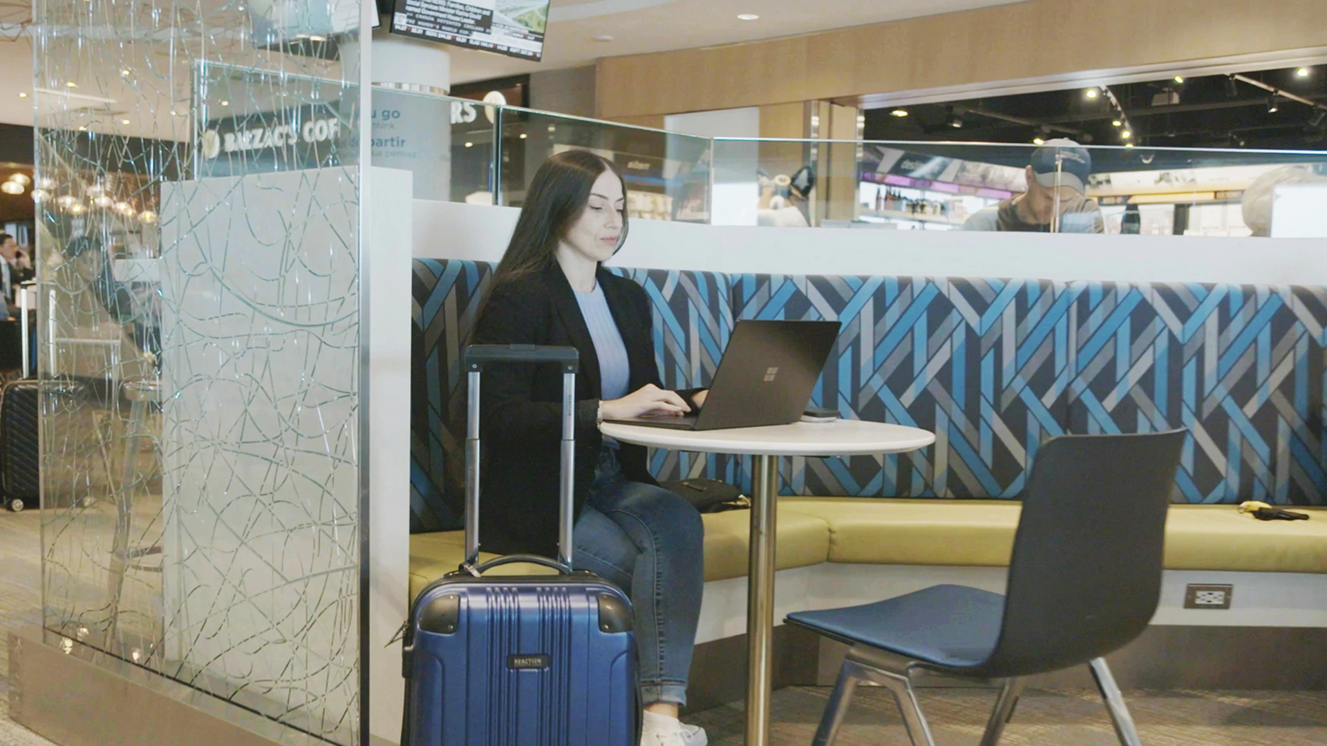 Lady working on a laptop in the airport lounge