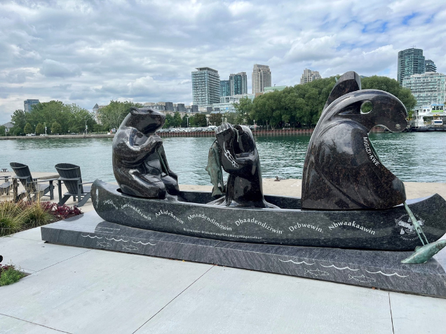 granite sculpture by water