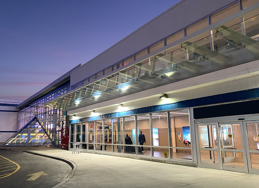 The illuminated mainland terminal entrance at Billy Bishop Airport.