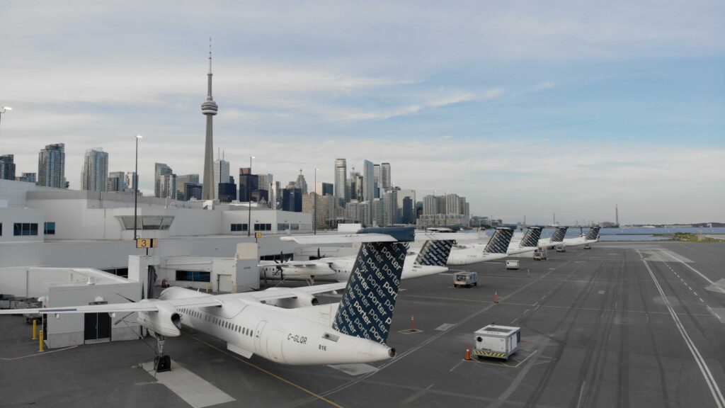 Aircraft at Billy Bishop Airport with the Toronto skyline in the background.