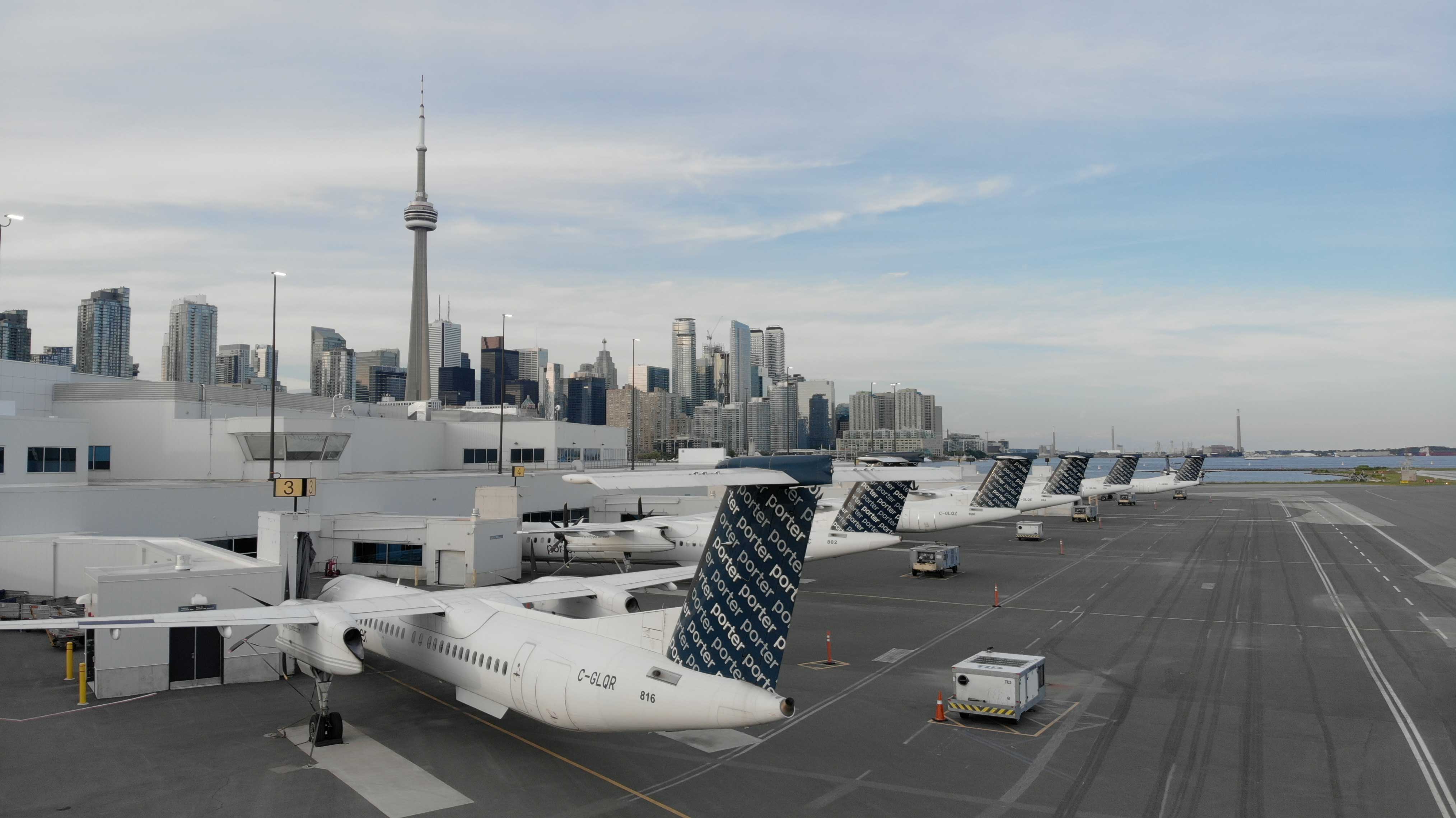 Aircraft at Billy Bishop Airport with the Toronto skyline in the background.