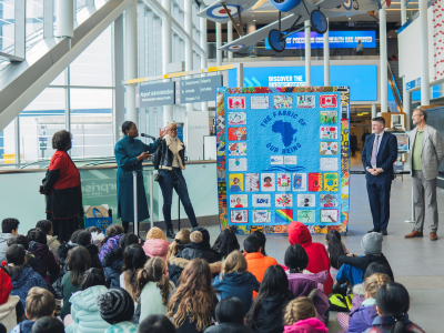 Visitors attend the unveiling of a textile installation in the airport atrium.