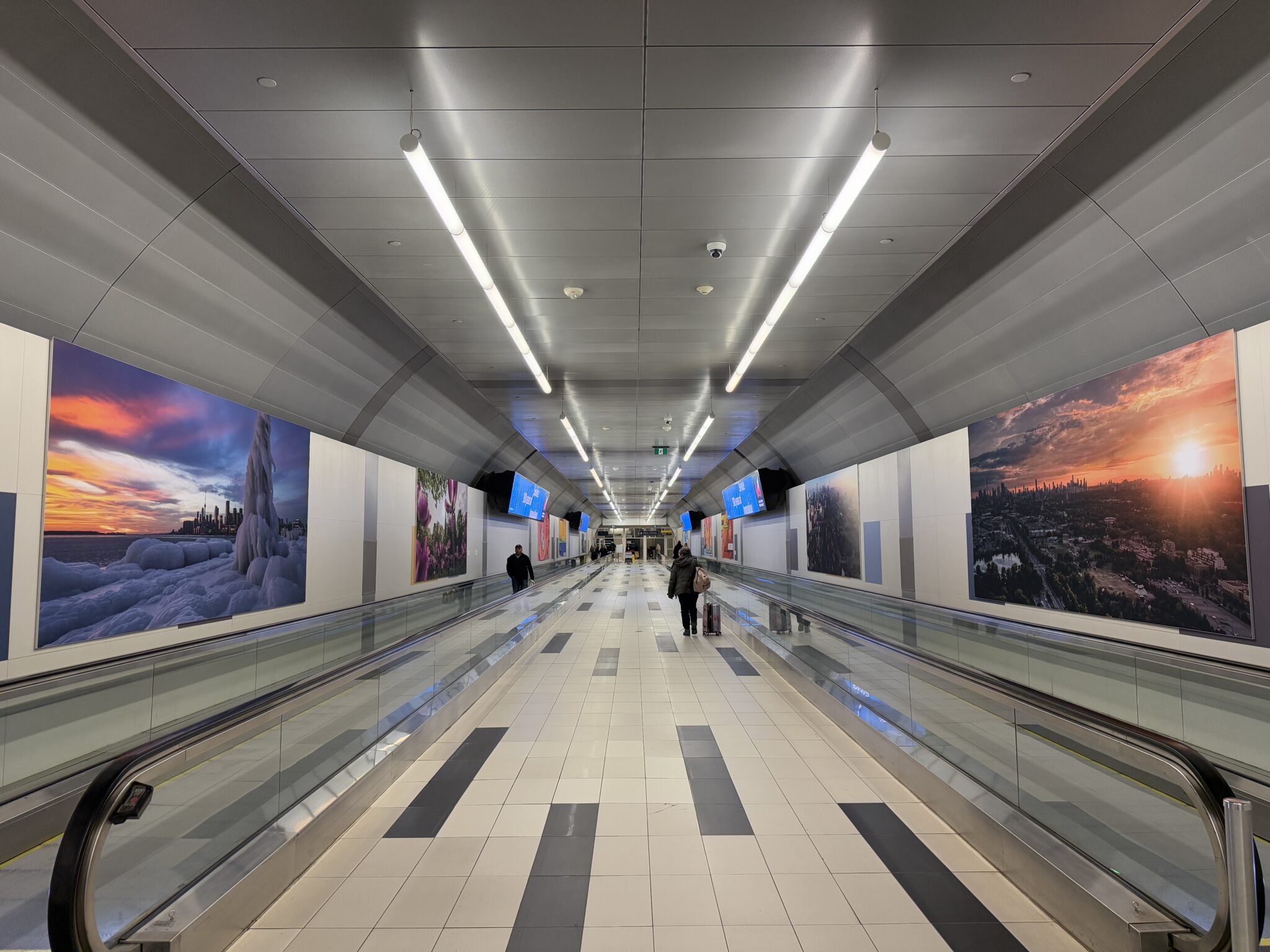 Artworks displayed along the airport pedestrian tunnel.