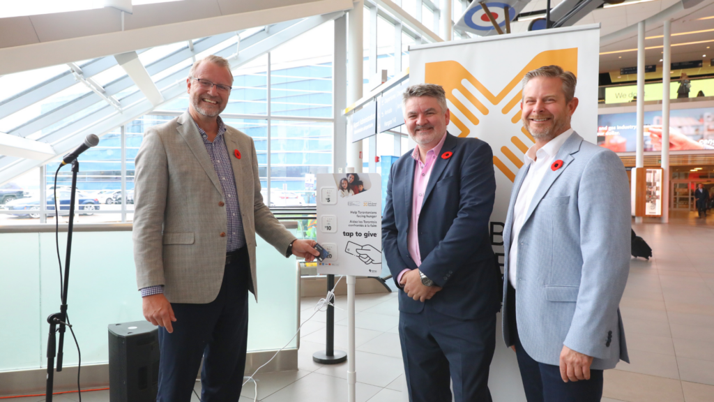 Representatives at the Daily Bread donation drive announcement in the airport atrium.