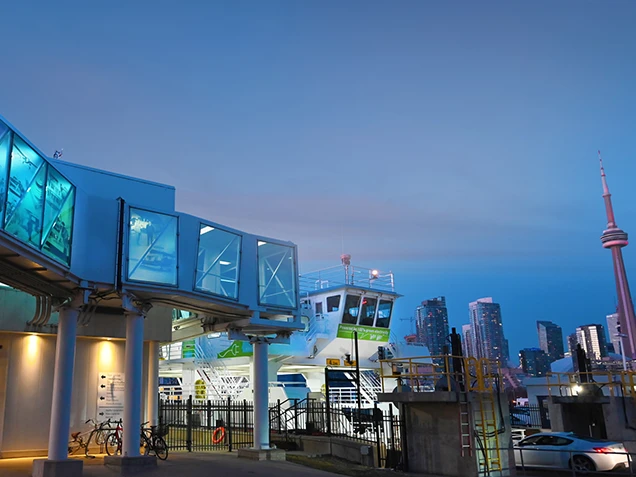 The airport mainland terminal illuminated blue at dusk.