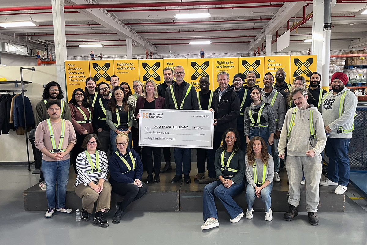 Airport team members present a donation cheque to Daily Bread Food Bank.