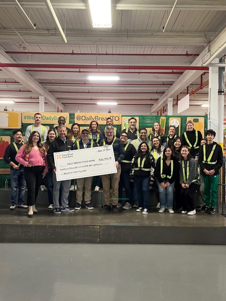 Airport team members present a donation cheque to Daily Bread Food Bank.