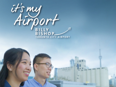 It’s My Airport campaign featuring two passengers overlooking the terminal.